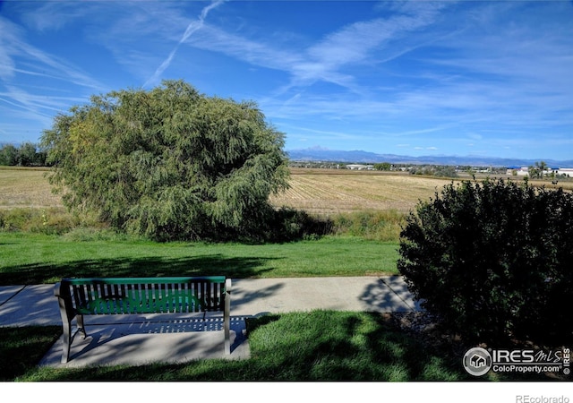 surrounding community with a yard and a rural view