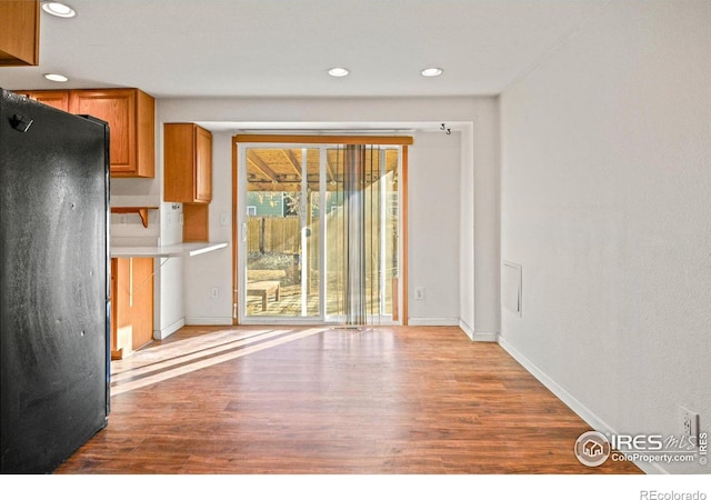 kitchen with black refrigerator and light wood-type flooring