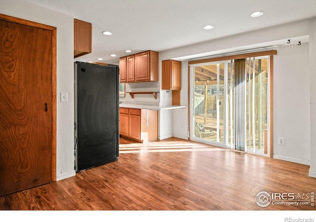 kitchen featuring light wood-type flooring and fridge