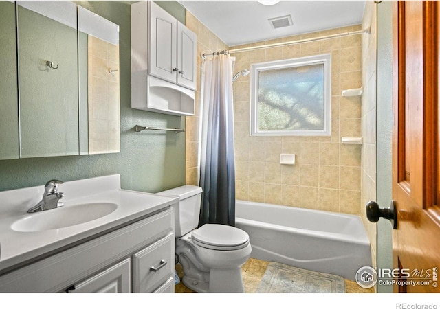 full bathroom with shower / bath combo, vanity, and toilet