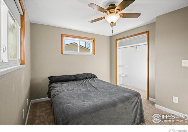 carpeted bedroom with ceiling fan and a closet