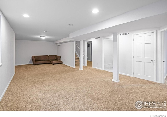 basement featuring light carpet