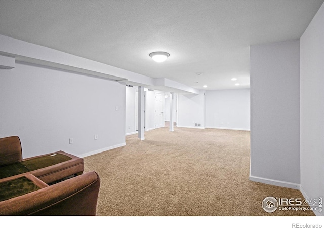 basement with carpet floors and a textured ceiling