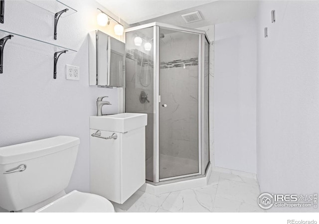 bathroom featuring toilet, a shower with shower door, and sink