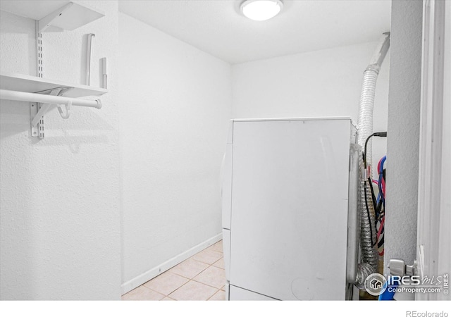 walk in closet with light tile patterned floors