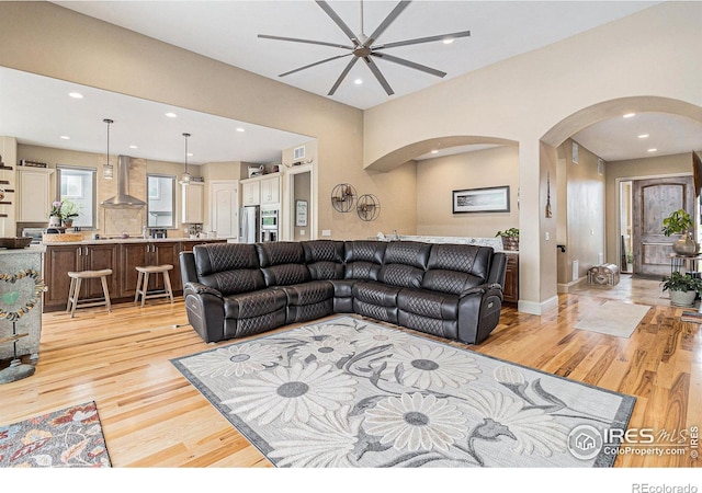 living room featuring ceiling fan and light wood-type flooring