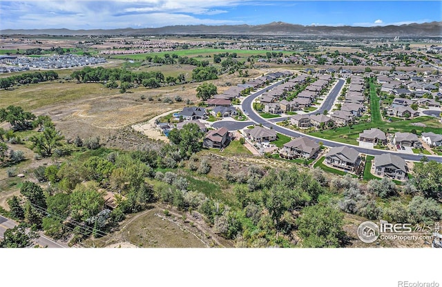 birds eye view of property with a mountain view