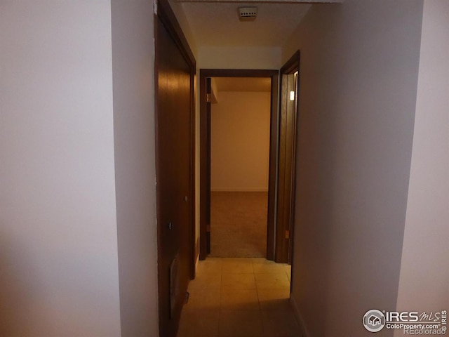 hallway with light tile patterned floors