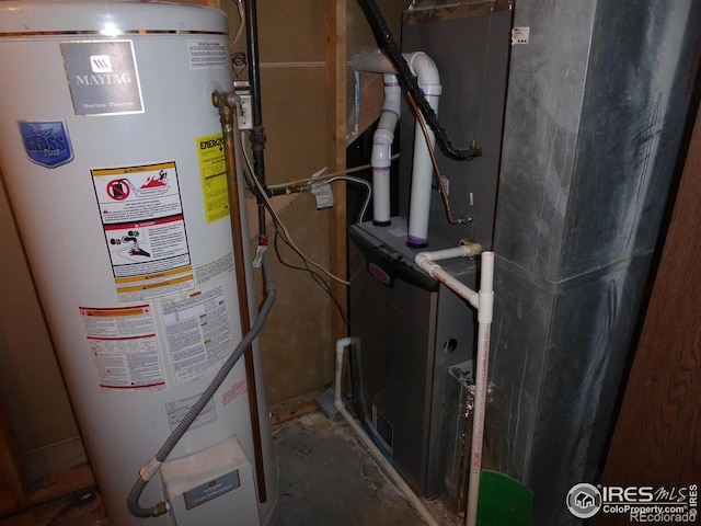 utility room with heating unit and gas water heater