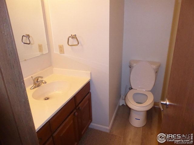 bathroom featuring hardwood / wood-style floors, vanity, and toilet