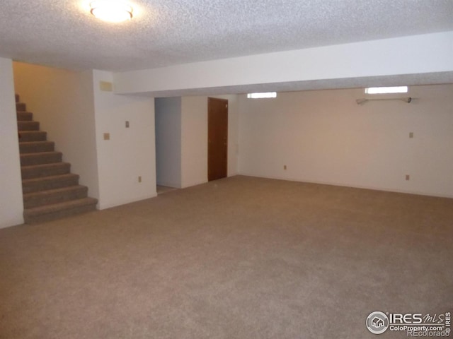 basement with carpet floors and a textured ceiling