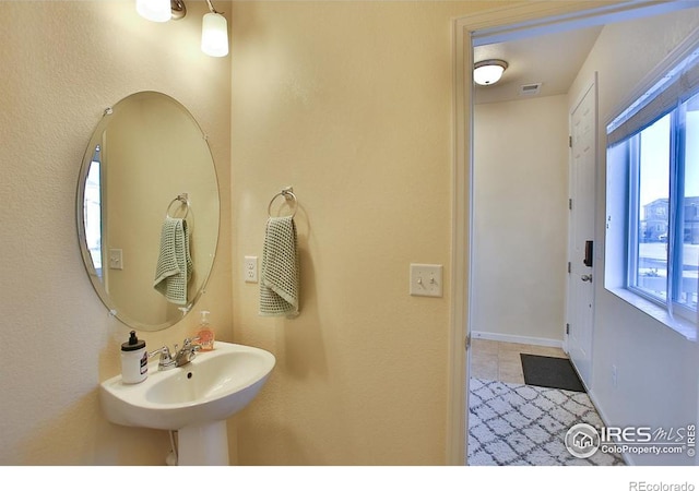 bathroom with plenty of natural light and sink