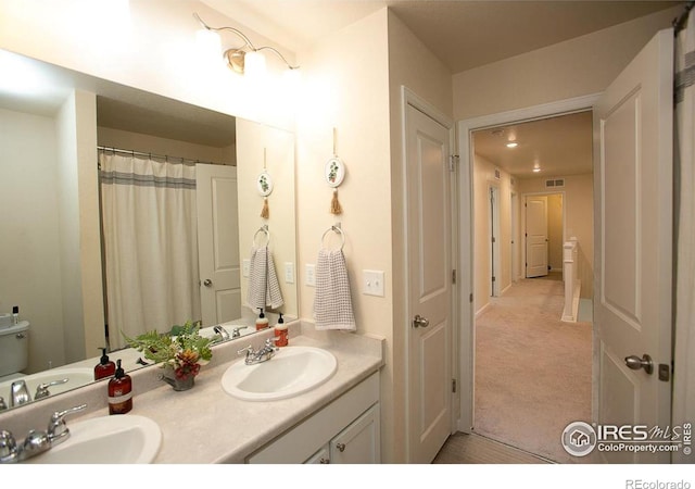 bathroom featuring vanity and toilet