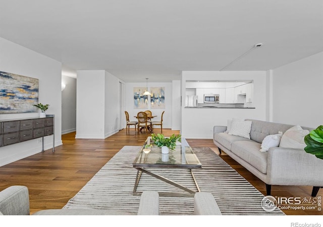 1850 Folsom St Unit 611, Boulder, CO 80302 - living area with wood finished floors, a chandelier, and baseboards