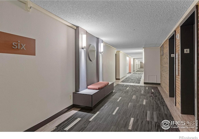 1850 Folsom St Unit 611, Boulder, CO 80302 - hallway featuring a textured ceiling and baseboards