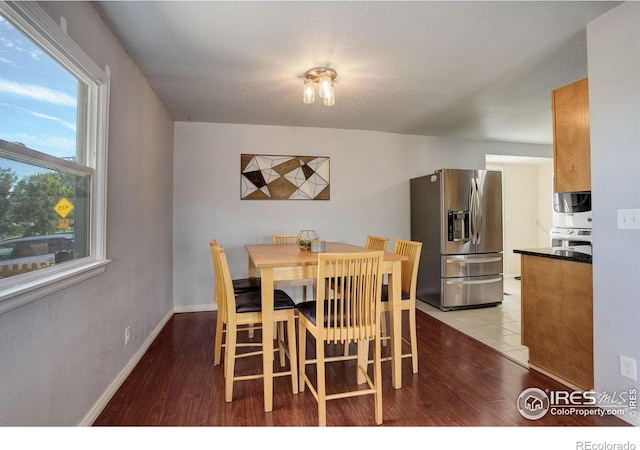 dining room with hardwood / wood-style flooring and a textured ceiling