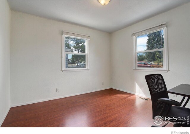 office space with dark hardwood / wood-style flooring