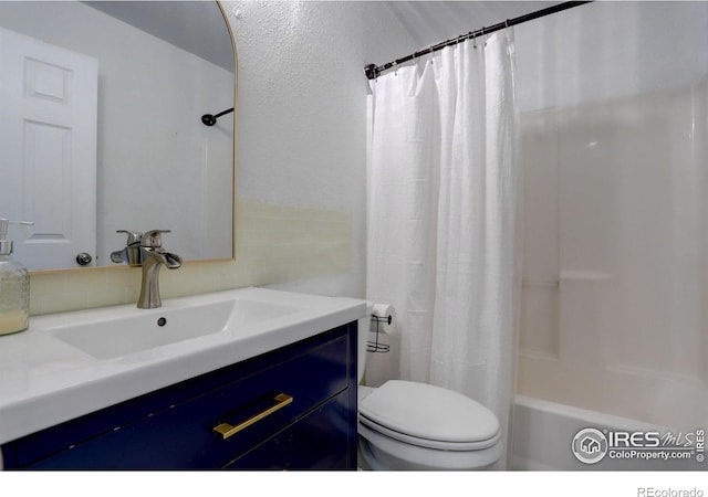 full bathroom with vanity, toilet, and shower / tub combo with curtain