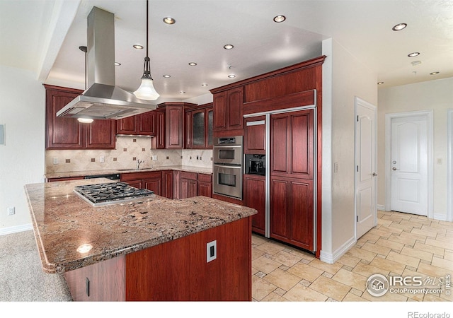 kitchen featuring appliances with stainless steel finishes, pendant lighting, tasteful backsplash, sink, and island exhaust hood