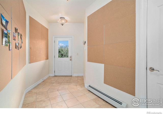 doorway to outside featuring a baseboard heating unit and light tile patterned floors