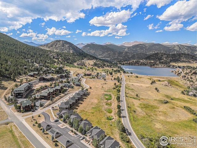 drone / aerial view with a water and mountain view