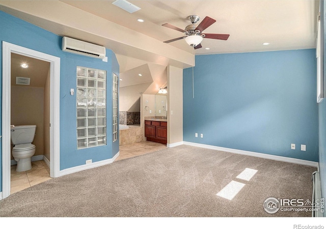 interior space with ensuite bath, lofted ceiling, light carpet, and an AC wall unit