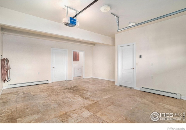 garage featuring baseboard heating and a garage door opener