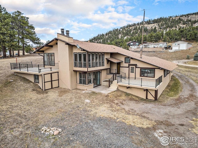 back of property featuring a mountain view