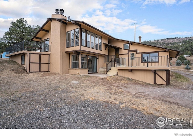 rear view of house featuring a balcony