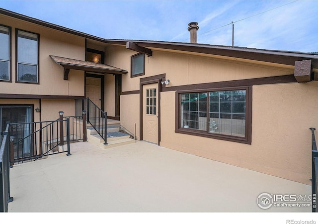 property entrance featuring a patio