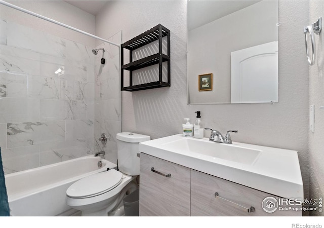 full bathroom with toilet, vanity, and tiled shower / bath combo