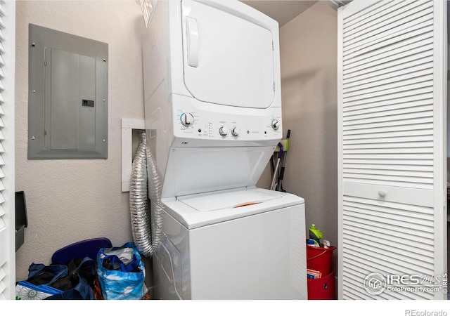 laundry area with stacked washing maching and dryer and electric panel