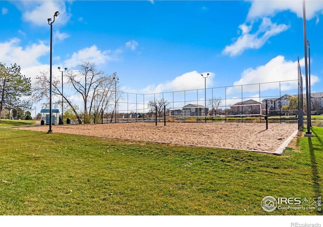 view of play area with a lawn and volleyball court