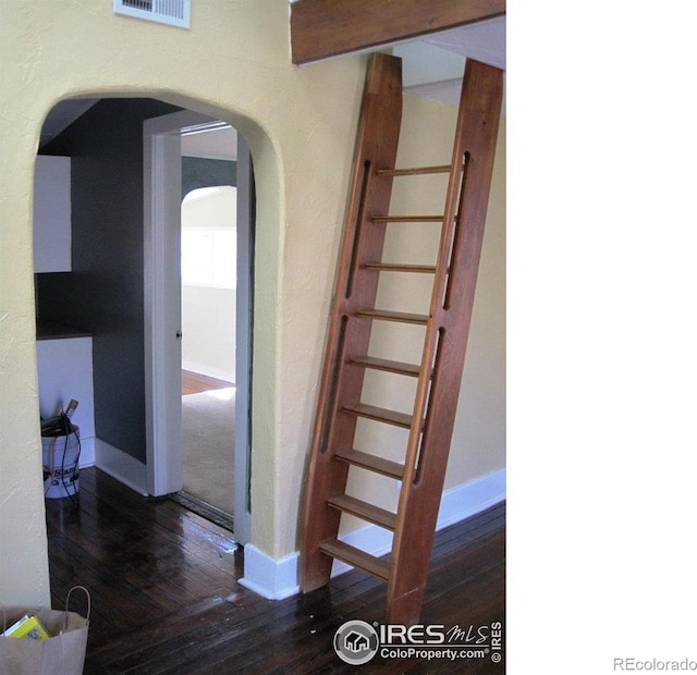 stairs featuring hardwood / wood-style floors