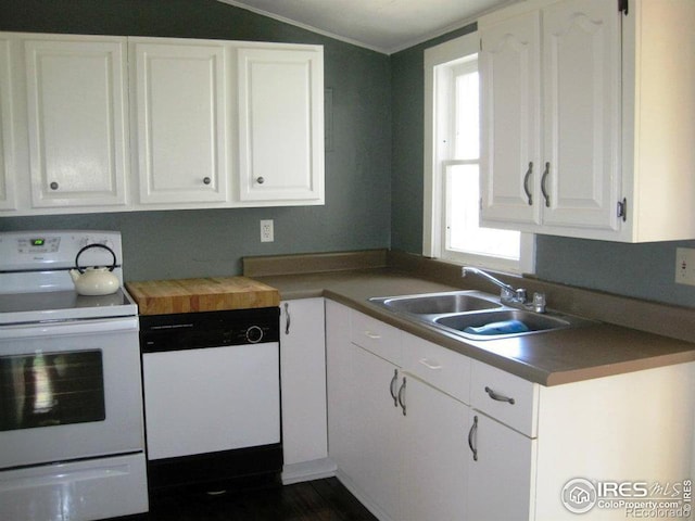 kitchen with lofted ceiling, white cabinetry, sink, and white appliances