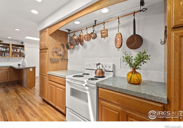 kitchen with recessed lighting, brown cabinets, open shelves, light wood finished floors, and white range with electric cooktop