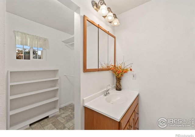 bathroom featuring stone finish floor and vanity