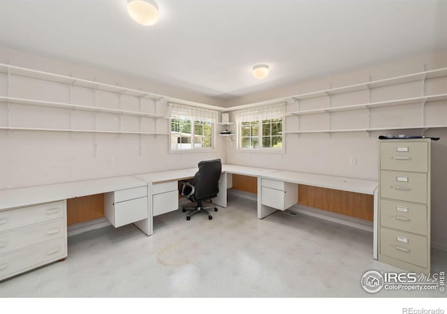 office space featuring light floors and built in desk