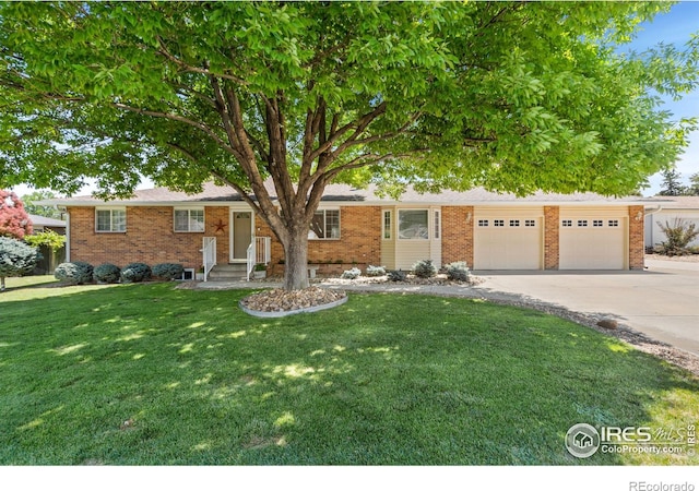 ranch-style home with a garage, driveway, brick siding, and a front yard