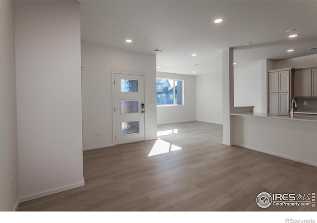 5086 Mckinnon Ct, Timnath, CO 80547 - unfurnished living room with light wood finished floors and recessed lighting