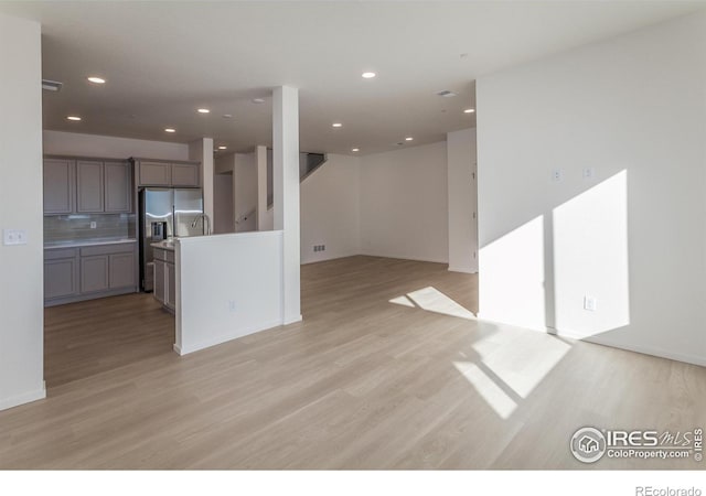 5086 Mckinnon Ct, Timnath, CO 80547 - unfurnished living room featuring light wood finished floors and recessed lighting
