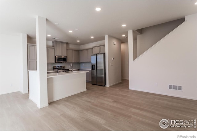 5086 Mckinnon Ct, Timnath, CO 80547 - kitchen with stainless steel appliances, gray cabinets, light wood-style floors, light countertops, and recessed lighting