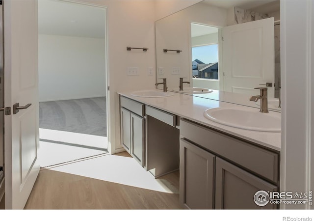 5086 Mckinnon Ct, Timnath, CO 80547 - bathroom featuring double vanity and wood finished floors