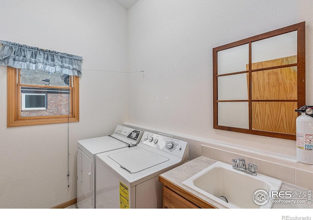 laundry area featuring sink and washing machine and clothes dryer