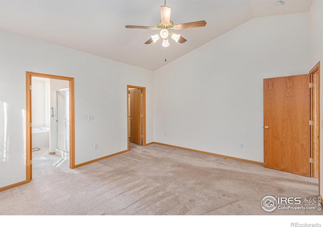 carpeted empty room featuring ceiling fan and lofted ceiling