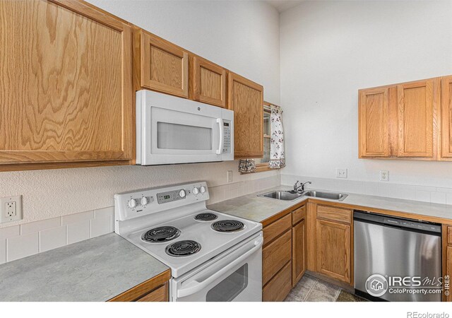 kitchen featuring white appliances and sink