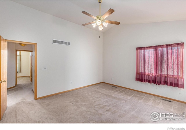 carpeted empty room with ceiling fan and vaulted ceiling