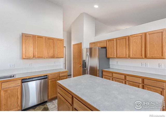 kitchen featuring stainless steel appliances and high vaulted ceiling