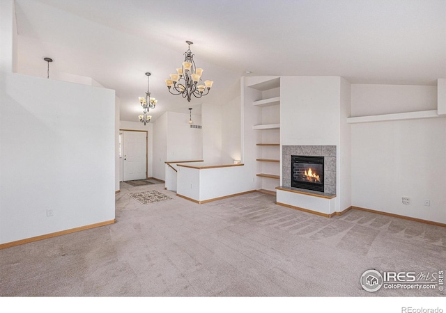 unfurnished living room with built in shelves, light colored carpet, and vaulted ceiling