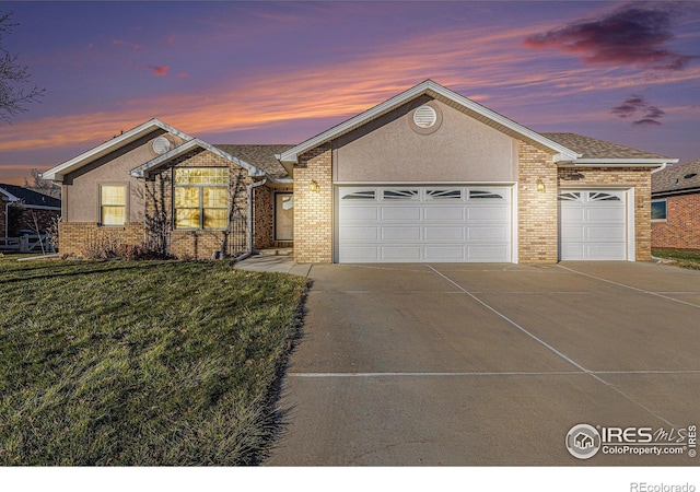 single story home with a yard and a garage